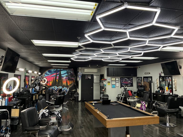 Modern gaming and entertainment room with hexagonal neon ceiling lights, pool table, gaming chairs, and arcade equipment