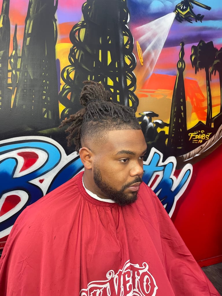 Man with braided hair in red barbershop cape against colorful futuristic city backdrop